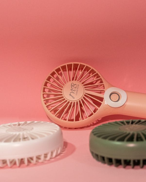 A makeup setup featuring the portable mini rechargeable fan by MB Cosmetics BZ