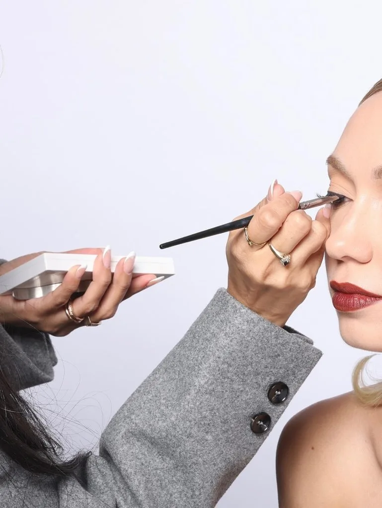 Maddie applying makeup on a client
