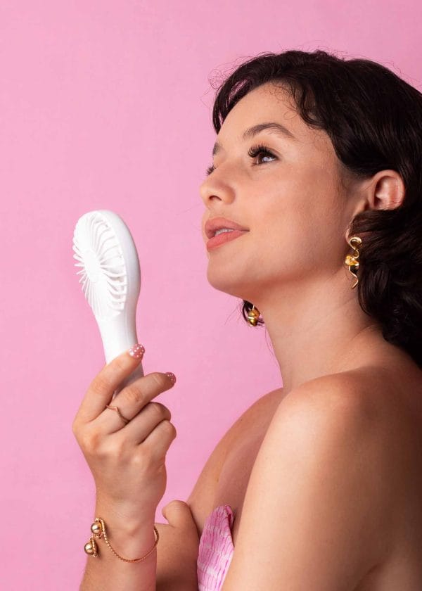 Model showing off her MB Cosmetics Mini Fan from the side view