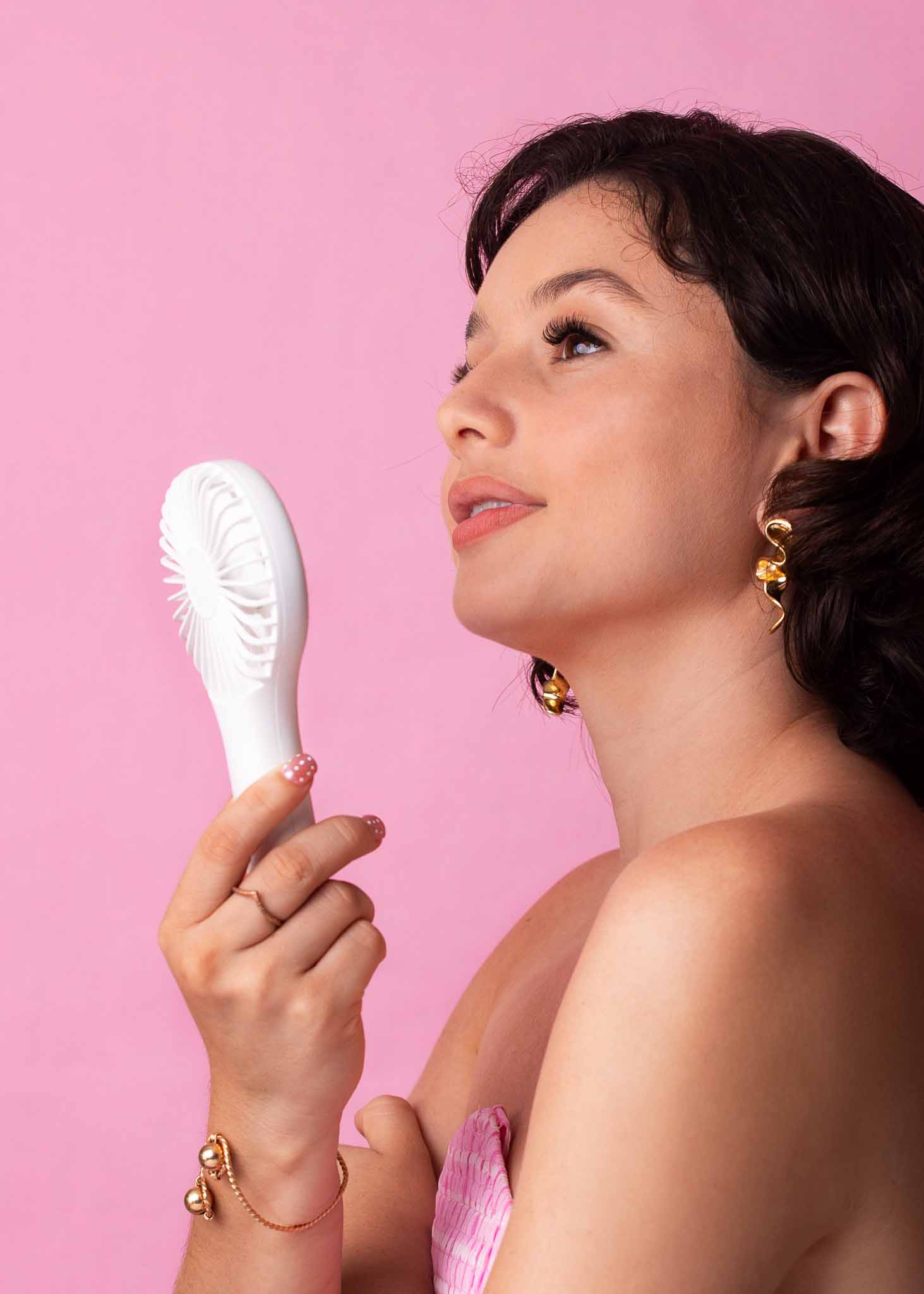 Model showing off her MB Cosmetics Mini Fan from the side view